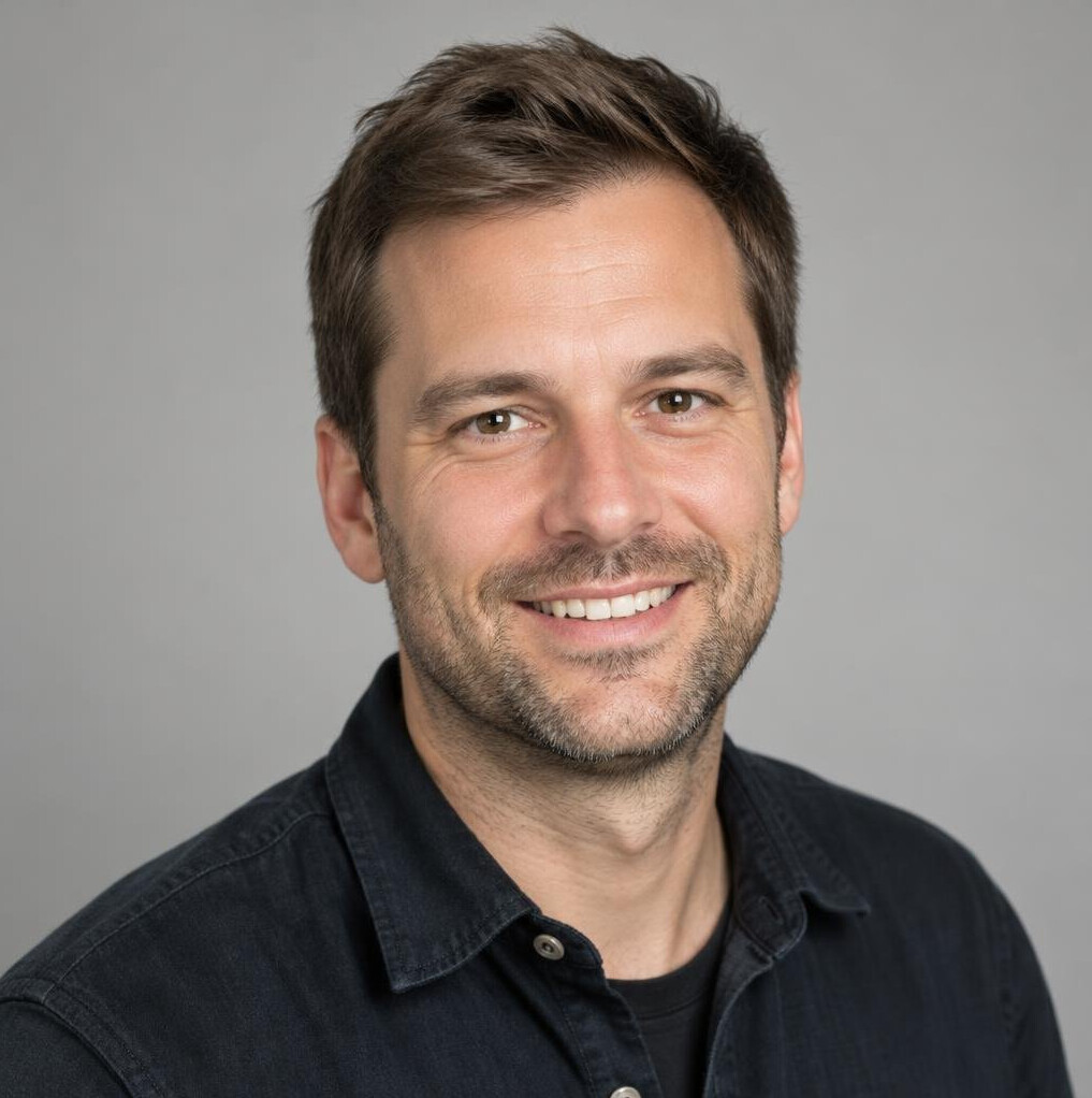 Portrait of a smiling man in his thirties with short brown hair