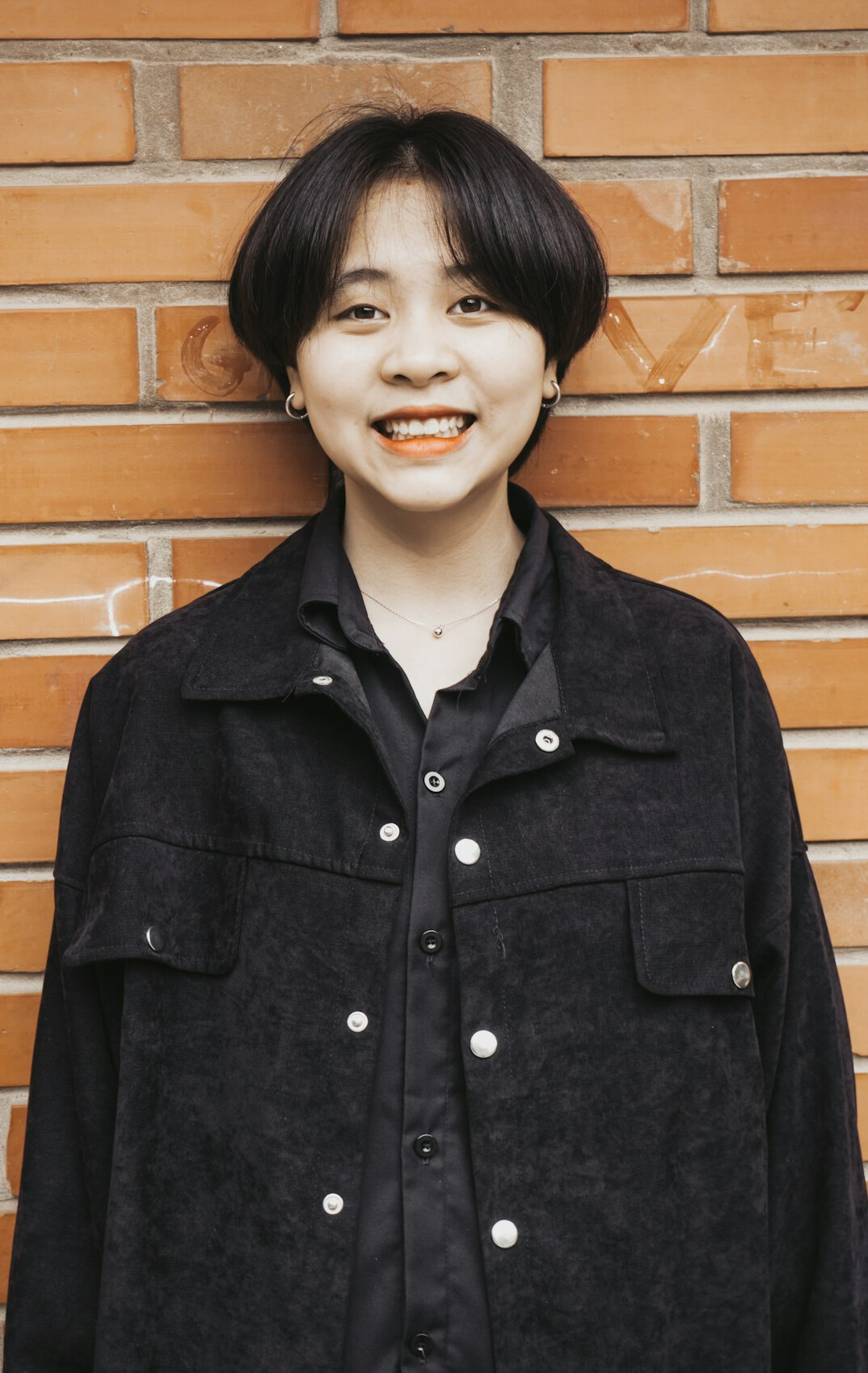 Portrait of a woman with short dark hair smiling